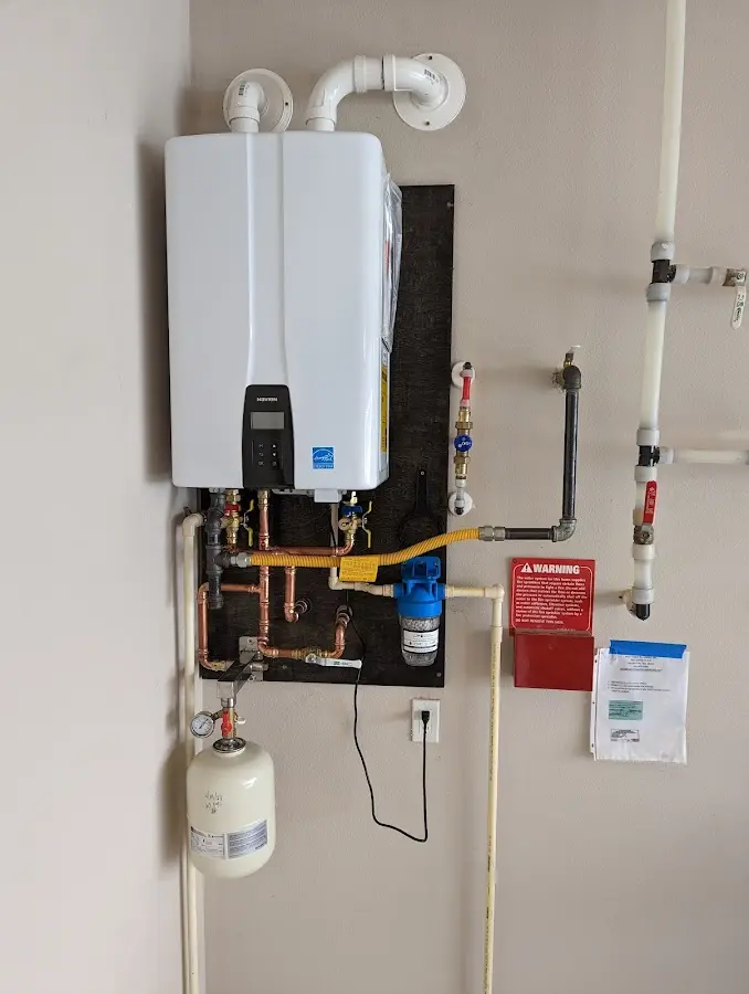 Professional plumber installing copper piping in a Duluth home